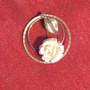 Carved bone rose brooch by Winard